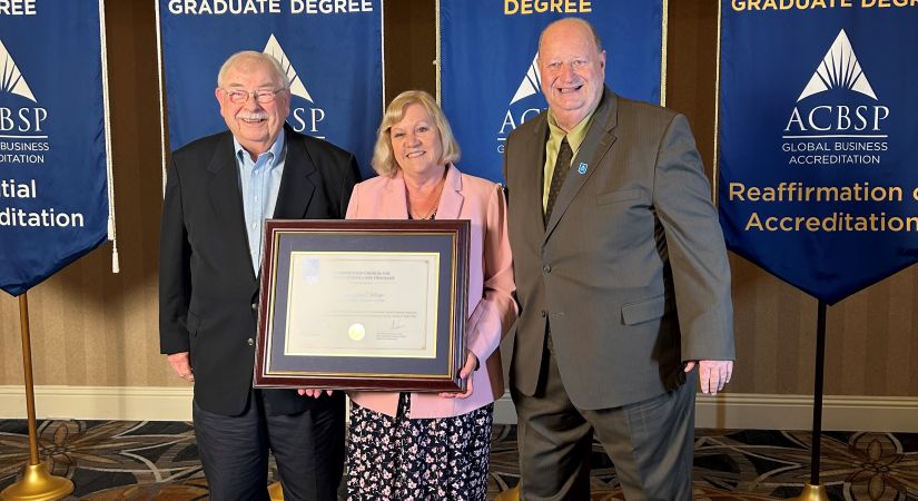 OC ACBSP Champions/Faculty members Laura Thurnheer (middle) and Michael Conlin (left) receiving the re-accreditation certificate from Chief Accreditation Officer for ACBSP Steve Pascale (right).
