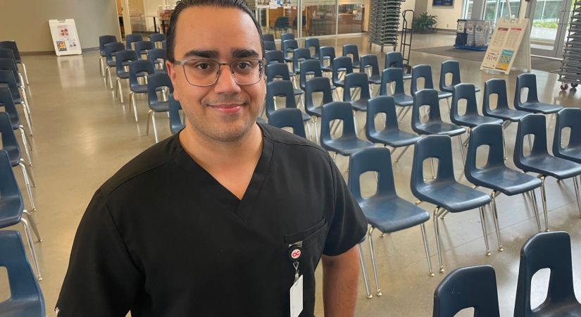 OC student Vaneet Verma standing in the OC atrium ahead of convocation.