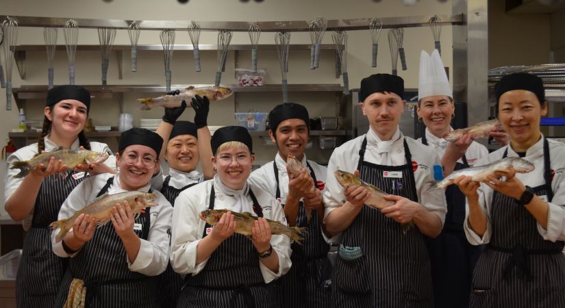 OC culinary arts students pose with Arctic Char 