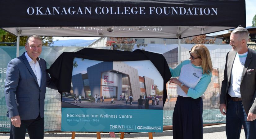The image shows three people unveiling a poster for the "OC Okanagan College Recreation and Wellness Centre," which is set to open in Summer 2025.
