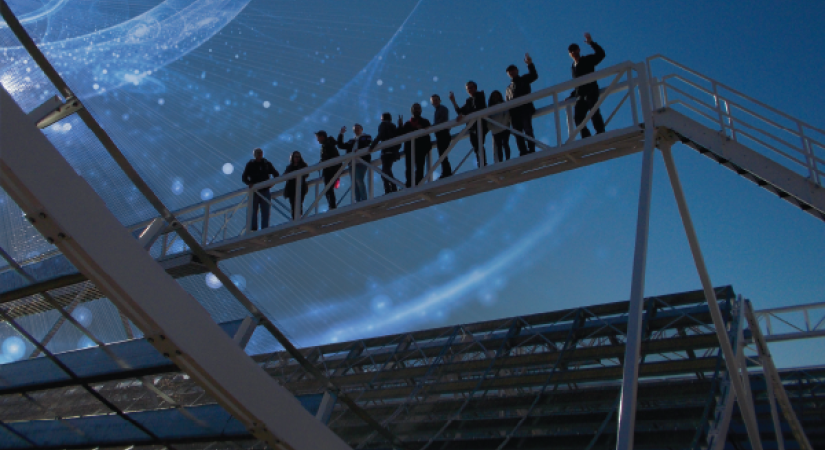 people standing on a platform at the observatory, night sky in the background