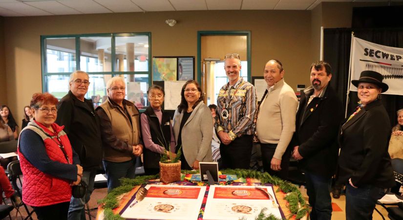 Event signatories posing with the House of Learning Parnership Agreement. From left: Kukpi7 Edna Felix of Splatsin, Kukpi7 Eddy Jules, Skeetchestn Indian Band, Tribal Kukpi7 Darrel Draney, Elder Lucy William, Kukpi7 Lynn Kenoras - Duck Chief, OC President Neil Fassina, Kukpi7 Frank Antoine, Bonaparte First Nation, Kukpi7 George Lampreau, Simpcw First Nation, Sunny Lebourdais of Whispering Pines/Clinton Indian Band.