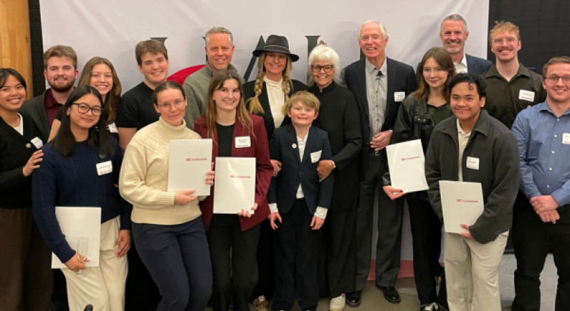 group photo of 17 people, mix of ages and genders, including the Hall family, OC President Neil Fassina, and students