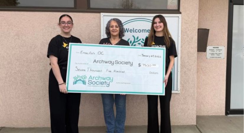 picture showing three women holding a giant cheque