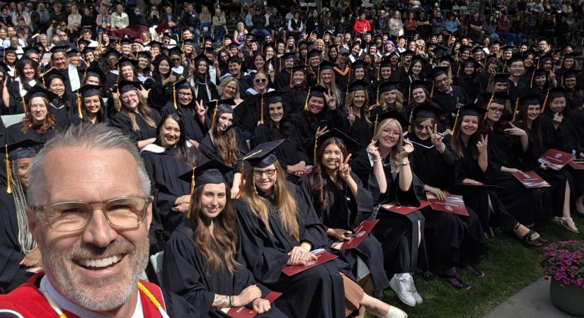 OC President Dr. Neil Fassina takes a selfie with students at the College's convocation event June 6.