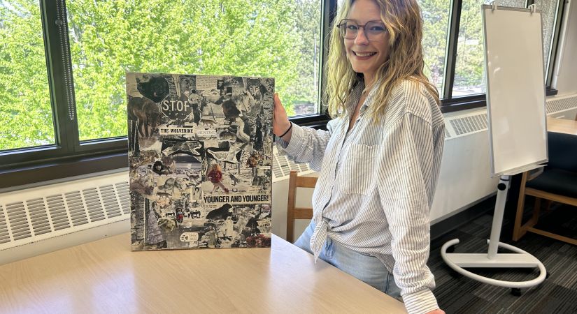 Mariah Matthews standing with her art work