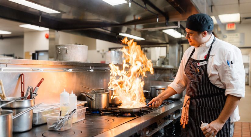 An OC culinary student works in one of OC’s learning kitchens.
